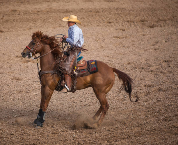 istock Cowboy riding at rodeo arena 1049585700
