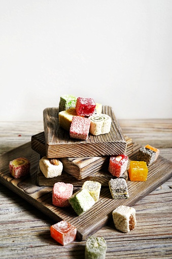 Turkish delight on white rustic background. Turkish deligh set. Assorted traditional turkish delight on oriental background.