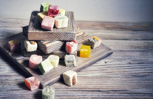 Turkish delight on white rustic background. Turkish deligh set. Assorted traditional turkish delight on oriental background.