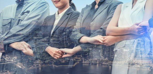 istock Double exposure business people holding hands. 1049589918