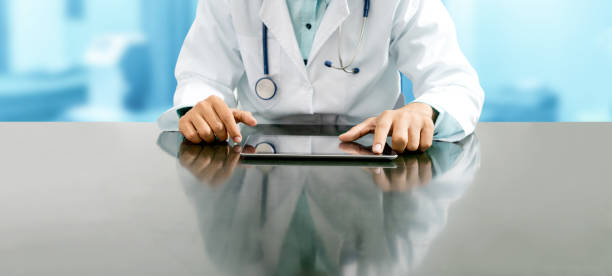 médico com computador tablet no escritório do hospital. - 2802 - fotografias e filmes do acervo