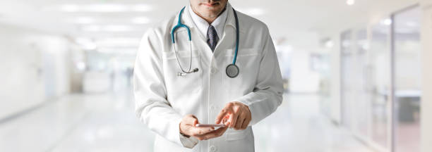 istock Male doctor using mobile phone at hospital. 1049592296