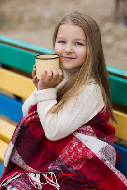 happy little girl boivent du thé en plein air - beach on child the photos et images de collection