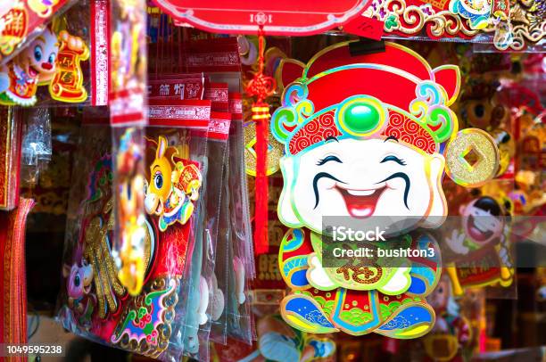 Chinese God Of Wealth Cai Shen Hanging At A Hong Kong Market Stall Stock Photo - Download Image Now