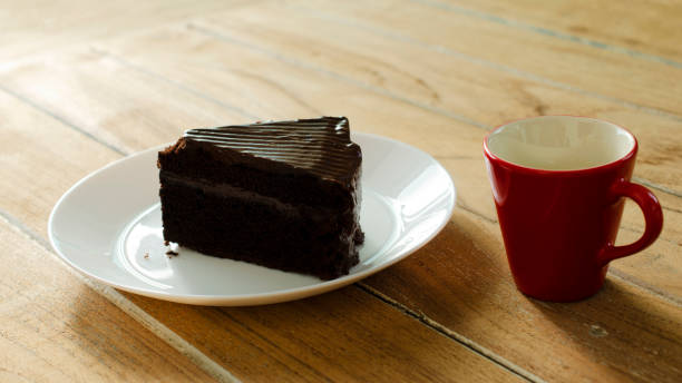 istock Chocolate cake and Red coffee hot drink on wooden table backgrounds 1049603670