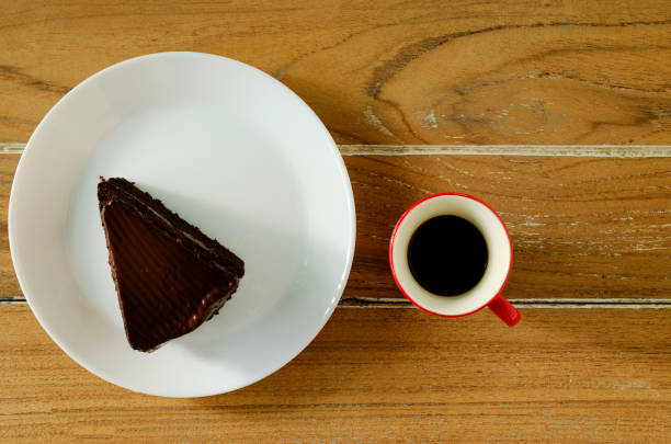 istock Chocolate cake and Red coffee hot drink on wooden table backgrounds above 1049603980