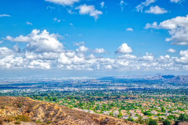 istock Rain leaves blue sky and white clouds over city 1049604824