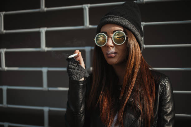 istock Fashionable woman smoking a cigarette 1049610126