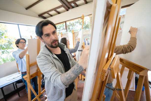 istock Man painting in an art class 1049623886