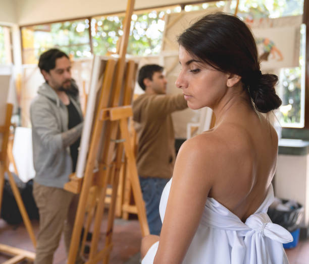 istock Woman posing as a live model in an art class 1049623932