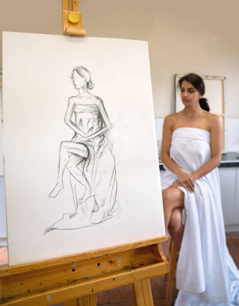 istock Woman posing as a live model in an art class 1049623964