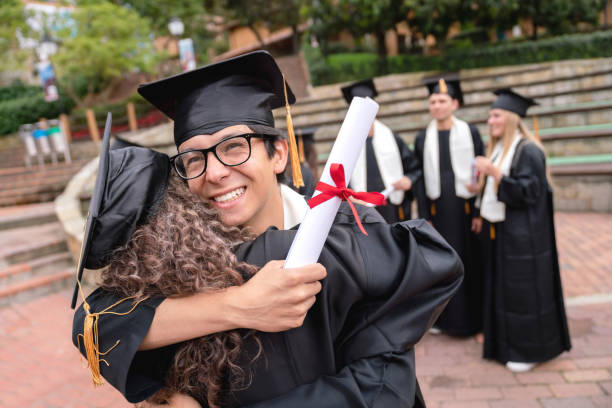 istock Happy students hugging and celebrating their graduation 1049624034