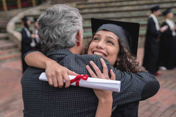 istock Happy student hugging her father and celebrating her graduation 1049624060
