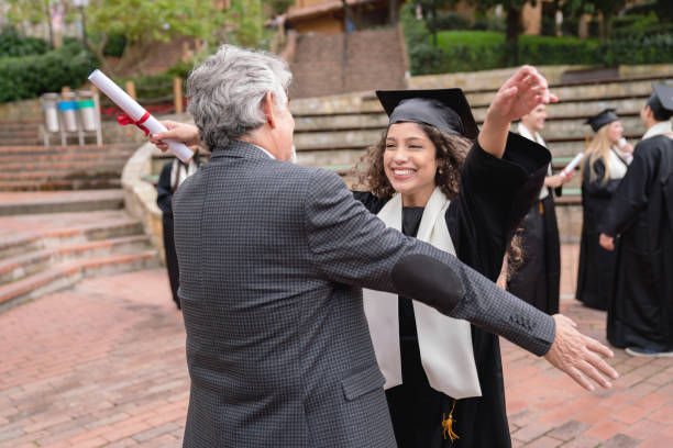 istock Happy student hugging her father and celebrating her graduation 1049624076