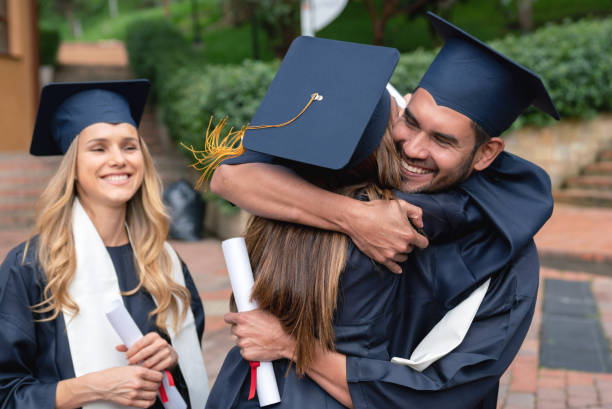 istock Happy students hugging and celebrating their graduation 1049624122