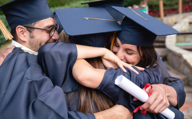 istock Happy group of students hugging and celebrating their graduation 1049624134