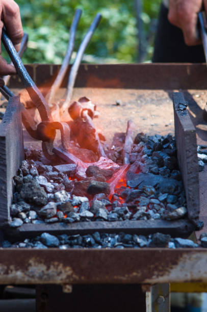 istock blacksmith furnace with burning coals, tools, and glowing hot metal workpieces 1049640140