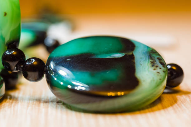 istock Large polished beads of beautiful translucent green agate gemstone, macro 1049640236