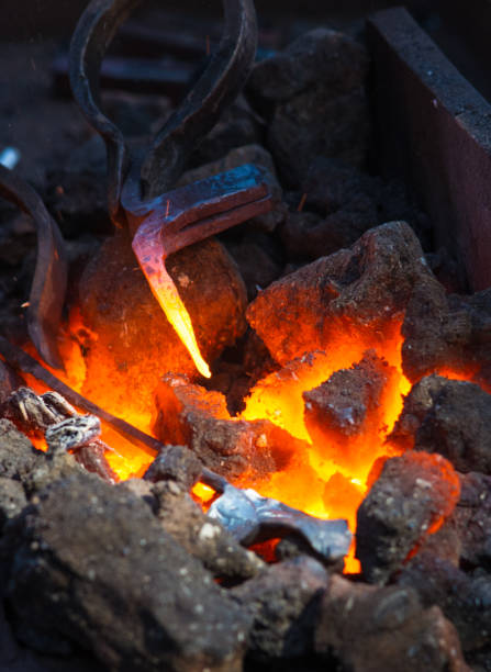 istock blacksmith furnace with burning coals, tools, and glowing hot metal workpieces 1049643860