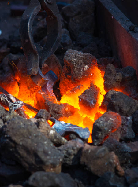 istock blacksmith furnace with burning coals, tools, and glowing hot metal workpieces 1049643892