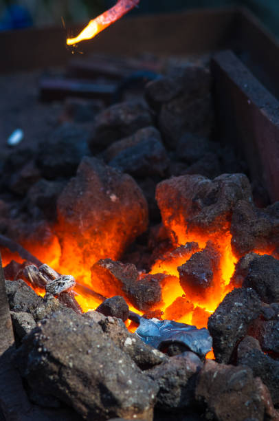 istock blacksmith furnace with burning coals, tools, and glowing hot metal workpieces 1049644162