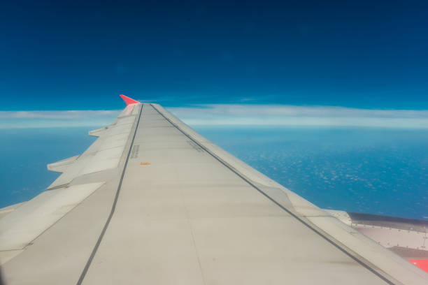 Wing of airplane with blue sky and cloud on day scene, Nature transport background