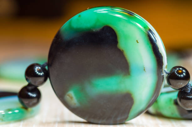 istock Large polished beads of beautiful translucent green agate gemstone, macro 1049646792