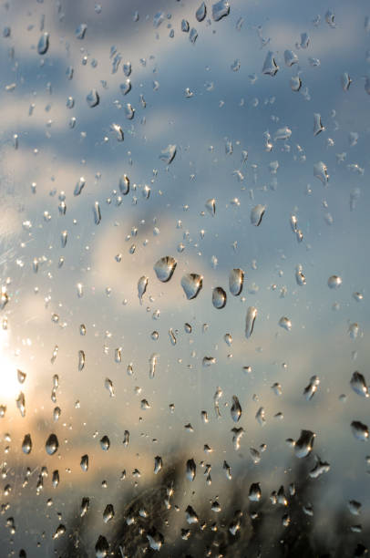 istock raindrops on window glass on background of cloudy sky 1049646964