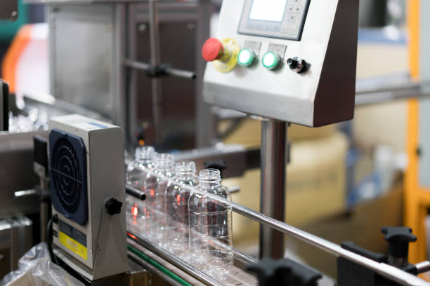 istock Clear Bottles transfer on Conveyor Belt System. Industrial and factory with machine technology concept. 1049647320