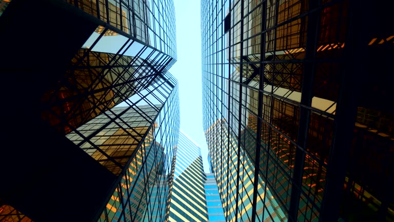 Modern skyscrapers in business district against blue sky