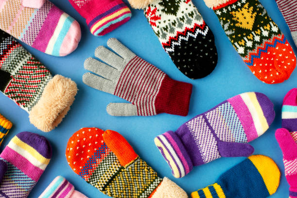 istock Mittens and gloves are scattered on the table. 1049656318
