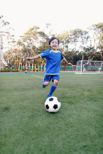istock Boy with soccer ball 1049659008