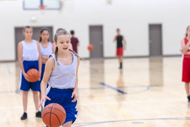 istock Co-ed teen basketball team practicing 1049659010