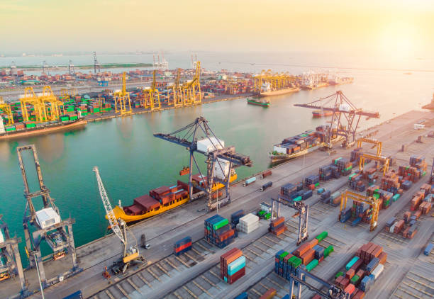 istock Container ship in export and import business and logistics. Shipping cargo to harbor by crane. Water transport International. Aerial view 1049662112