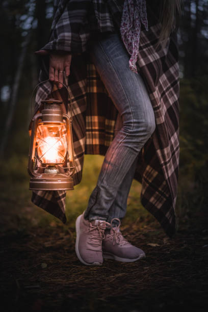 istock Girl in the forest with an old lantern 1049667198