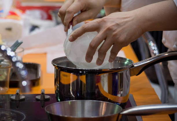 istock Chef preparing food, meal, in the kitchen, chef cooking, Chef decorating dish, closeup, chef at work 1049672972