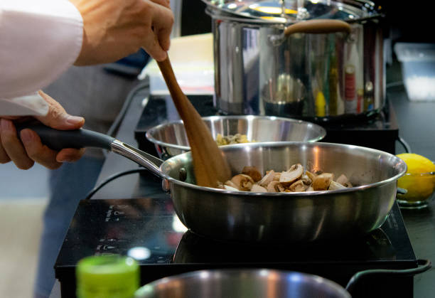 istock Chef preparing food, meal, in the kitchen, chef cooking, Chef decorating dish, closeup, chef at work 1049673006