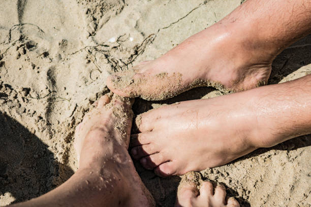 istock Couple on the beach. Close up legs image 1049676430