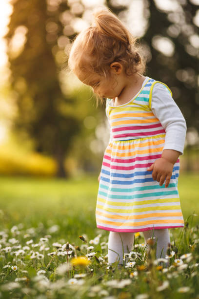 istock Girl walking on flower field 1049685114