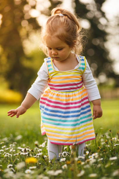 istock Girl walking on flower field 1049685136