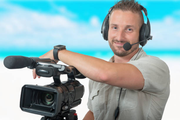 istock cameraman with professional a camcorder and headphones 1049688366