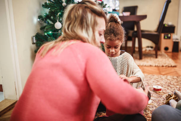 istock Mixed race family packing Christmas presents 1049694078