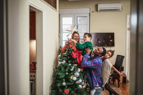 istock Mixed race family decorating Christmas tree 1049694096