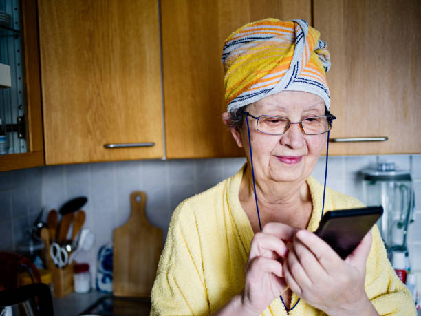 Real mother in law in domestic kitchen Real mother in law in domestic kitchen mother in law stock pictures, royalty-free photos & images