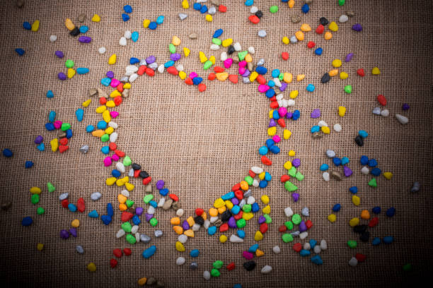 istock Colorful pebbles form a heart shape on canvas ground 1049697116
