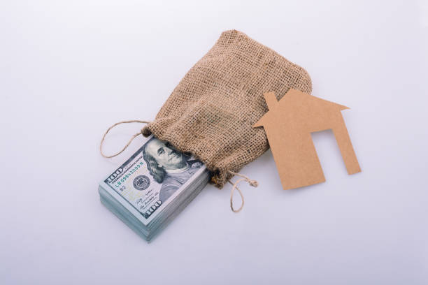 istock Paper house beside US dollar banknote 1049697234