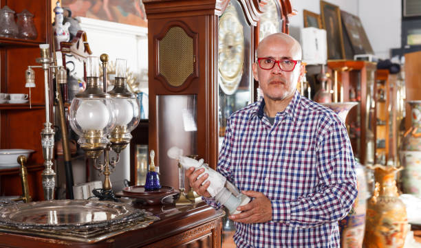 istock Thoughtful man examining vintage goods 1049697590