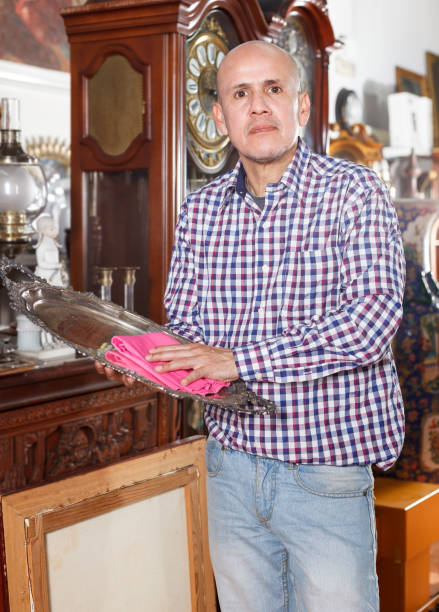 istock man wiping dust on ancient tray 1049697598
