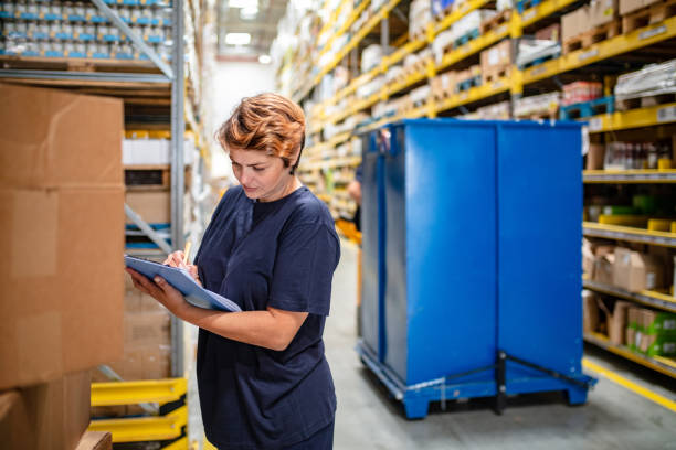 istock Woman with checklist by cardboard boxes 1049697636
