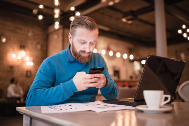 istock Young, redhead businessman, on coffee break, using mobile phone 1049697638
